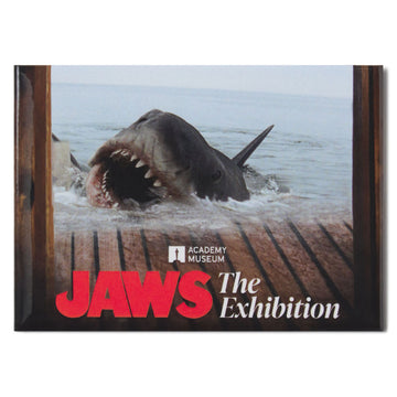 Promotional poster for 'Jaws: The Exhibition' featuring a shark emerging from water.